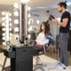 Salon station storage cabinet in black with 6 hair dryer holders, featuring drawers and ample storage for beauty tools.