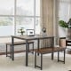 Brown dining table set with two benches shown in a stylish living room, perfect for modern dining and compact spaces.