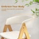 Curved backrest of a beige accent armchair with natural wood frame, designed for comfortable dining and relaxation.