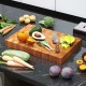 End grain cutting board made of solid teak wood, featuring natural waxes and oils, ideal for slicing and serving.