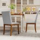 Upholstered dining chairs with padded seats and walnut legs, featuring decorative nailhead trim for elegant dining.