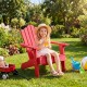 Red kids Adirondack chair with tilted high backrest, perfect for outdoor relaxation in the backyard or garden.