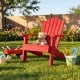 Red kids Adirondack chair with tilted high backrest, perfect for outdoor use in the backyard or porch.