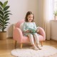 Kids armchair in pink with comfy backrest and armrests, perfect for reading in a cozy home or kindergarten setting.