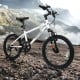 Kids mountain bike in white with 20-inch wheels, featuring adjustable saddle, suspension fork, and large pneumatic.