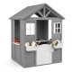 Gray wooden kids outdoor playhouse with sink, half door, and flower boxes for imaginative play in the backyard.