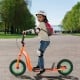 Kids scooter in orange with adjustable handlebar, inflatable wheels, and non-slip deck for outdoor adventures.