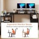 L-shaped desk with reversible monitor stands, ergonomic design, and built-in power outlet for versatile workspace use.