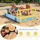 Large car-themed sandbox made of splinter-free fir wood, featuring a rotatable rudder and storage for sand toys.