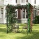 Large garden arch trellis in black, ideal for climbing plants, providing shade and support for outdoor relaxation.