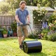 Lawn roller being used in a garden, 12-gallon water/sand filled for effective lawn leveling and maintenance.
