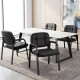 Set of four black leather office reception chairs with cushioned seats and ergonomic backrests for comfort and support.
