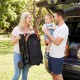 Lightweight black baby stroller with one-hand folding design, shown being carried by a parent for easy transport.