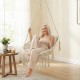 Macrame swing chair in beige with removable cushions, featuring a sturdy metal frame for indoor or outdoor use.