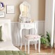 Elegant white makeup dressing table with curved legs and three spacious drawers, featuring a cushioned floral stool.
