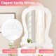 Elegant fan-shaped mirror with floral pattern, part of a white makeup dressing table set with cushioned stool.
