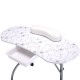 Foldable portable manicure table with floral design, white cushion, drawer, and casters for easy mobility and storage.