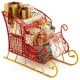 Metal Christmas Santa sleigh basket with gifts, featuring a red frame and golden base, perfect for holiday storage.