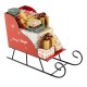 Red metal Christmas Santa sleigh basket filled with wrapped gifts, perfect for festive storage and holiday decor.