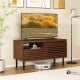 Mid Century fluted TV stand in walnut with open compartment and drawer, perfect for 40-inch TVs in modern interiors.