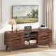 Mid Century Modern entertainment center in walnut with grille-style sliding doors, perfect for TVs up to 65 inches.