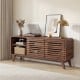 Mid-century modern entertainment center in walnut showcasing curved edges, grille-style sliding doors, and spacious.