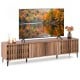 Mid-century modern entertainment center in walnut with slatted doors and four storage cabinets for living room.