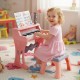Mini keyboard piano for kids in pink with 25 keys, microphone, and matching stool, perfect for toddlers' music play.