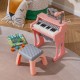 Mini keyboard piano for kids in pink with 25 keys, matching stool, and microphone, perfect for toddlers' music play.