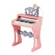 Mini keyboard piano for kids in pink with 25 keys, microphone, and matching stool for musical fun.