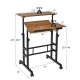 Mobile standing desk with adjustable height and tilting surface, walnut finish, ideal for small spaces and versatile.