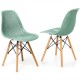 Hollow plastic dining chair in mint green with beech wood legs, showcasing modern design and comfort for small spaces.