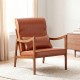Modern accent chair in brown faux leather with solid rubber wood frame, featuring removable cushions for cozy support.