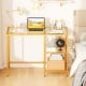 Modern console table with a gold metal frame, tempered glass top, and two open shelves for stylish home office use.