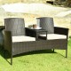 Modern patio conversation set featuring two seats with beige cushions and a trapezoid coffee table for outdoor.