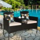 Modern patio conversation set featuring a trapezoid coffee table, beige cushions, and durable rattan for outdoor.