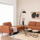 Close-up of the modular L-shaped sectional sofa's orange fabric texture, showcasing plush cushions and ergonomic design.