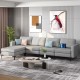 Light gray modular L-shaped sectional sofa with reversible ottoman and USB ports, perfect for modern living rooms.