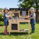 Kids playing with the Mud Kitchen Playset featuring removable sinks, stoves, and a water box for outdoor fun.