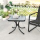 Tempered glass top patio table with a sturdy metal frame, positioned beside a chair, ideal for outdoor relaxation.