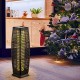 Black solar-powered wicker floor lamp with warm yellow LED light, ideal for outdoor use on patios or gardens.