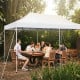 Outdoor pop-up patio canopy tent in white, accommodating 16-20 people, ideal for backyard gatherings and events.