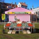 Foldable pink pop-up canopy with adjustable height, perfect for outdoor events, featuring a banner strip for promotions.
