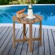 Round brown weather-resistant Adirondack side table with slatted top, perfect for outdoor use by the pool.