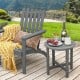 Gray 18-inch round weather-resistant Adirondack side table with slatted top, perfect for outdoor use beside a chair.