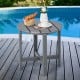 Gray 18-inch round weather-resistant Adirondack side table with slatted top, perfect for outdoor use by the pool.