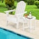 White 18-inch round weather-resistant side table beside an Adirondack chair, perfect for outdoor use by the pool.