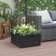 Fillable black umbrella base with planter box, featuring a large tabletop and drainage hole for outdoor use.