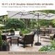 Double-sided 15 FT x 9 FT beige patio umbrella with crank handle, providing ample shade for outdoor furniture.