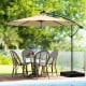 10-foot cantilever umbrella in beige with solar LED lights, supported by a sturdy base, perfect for outdoor dining.
